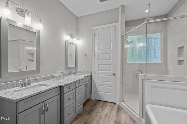 a view of walk in closet with clothes