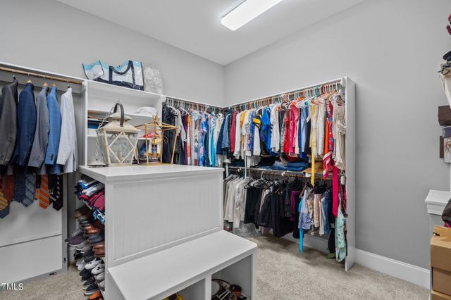 a view of a backyard with table and chairs and wooden fence