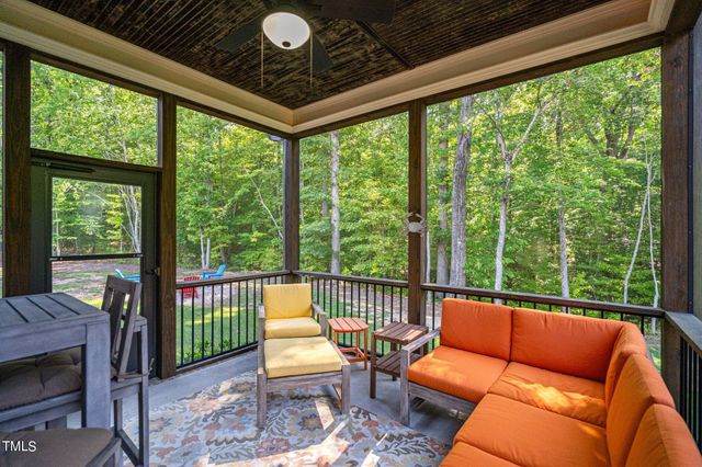 a backyard of a house with table and chairs