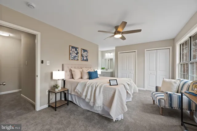 a bedroom with bed and a large window