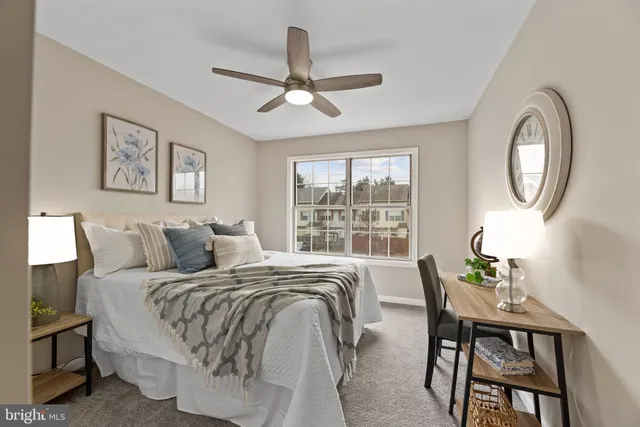 a bedroom with a bed and a lamp on table