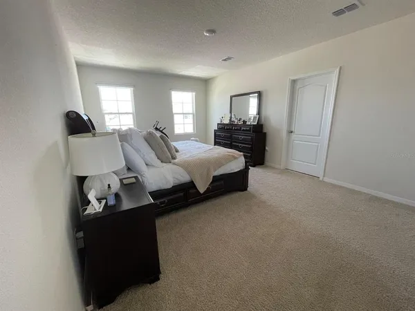 a bed room with bed and window