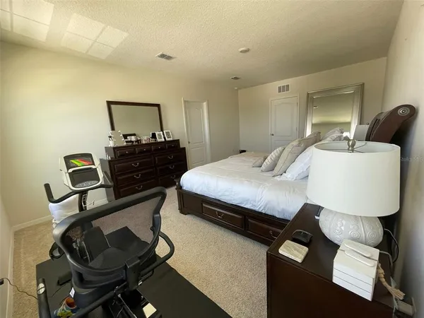 a bedroom with a bed and dresser