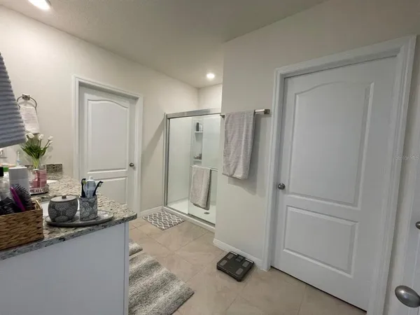 a bathroom with a double vanity sink a mirror and a shower