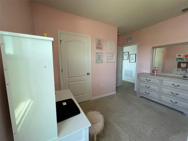 a room with a walk in closet and wooden floor