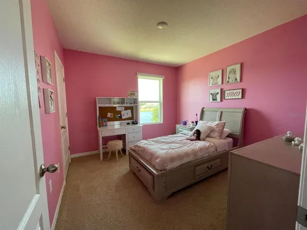 a bedroom with a bed and a dresser