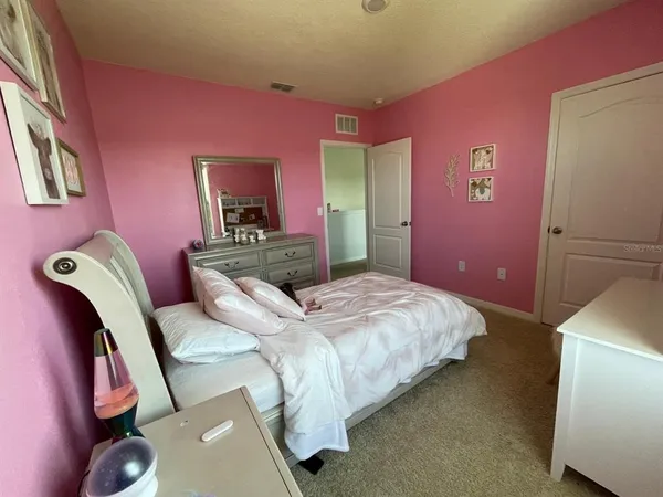 a bedroom with a bed and a couch