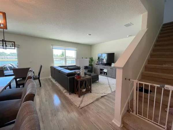 a living room with furniture flat screen tv and a window