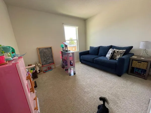 a living room with furniture a window and a flat screen tv