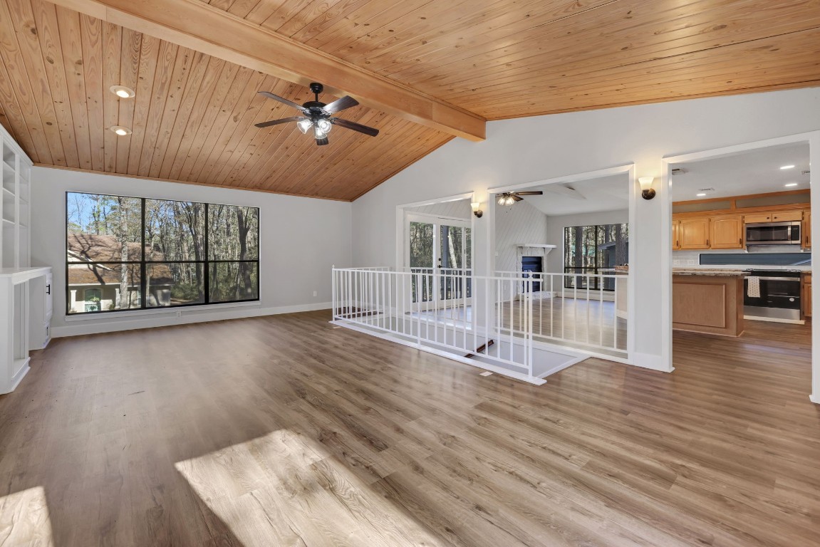 330 North Fairway Loop Coldspring, TX 77331 - Photo 1 of 40 an empty room with wooden floor and windows