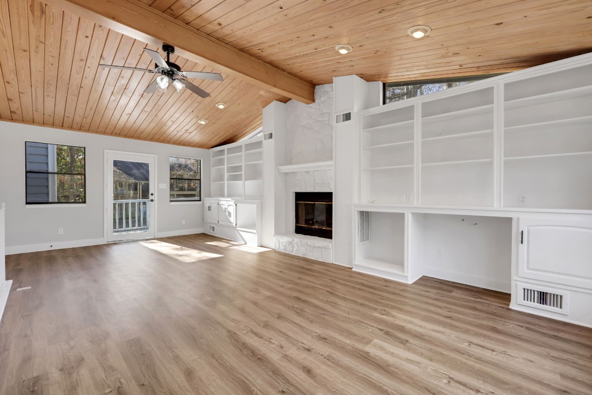 330 North Fairway Loop Coldspring, TX 77331 - Photo 4 of 40 a view of an empty room with wooden floor and a fireplace
