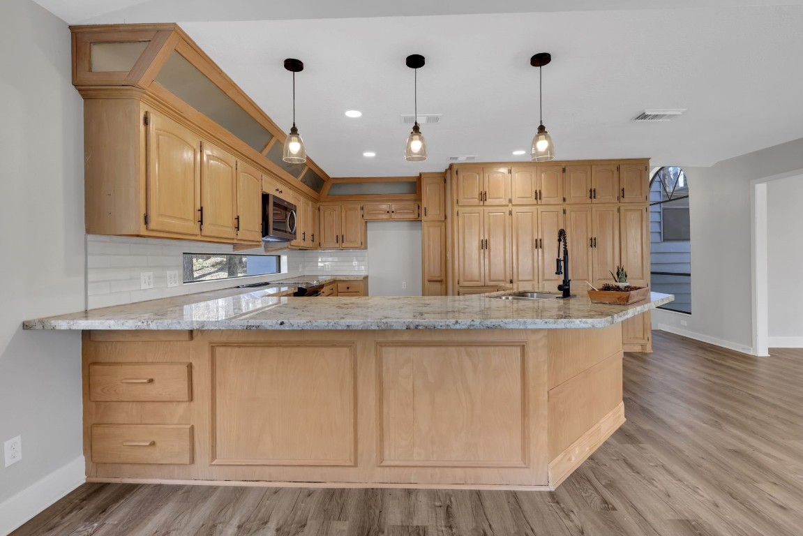 330 North Fairway Loop Coldspring, TX 77331 - Photo 8 of 40 a kitchen with stainless steel appliances granite countertop a sink a stove and a refrigerator