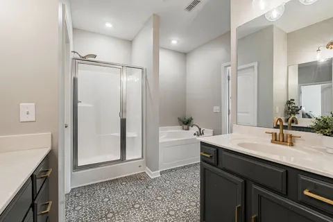 a bathroom with a granite countertop sink a mirror and a bathtub