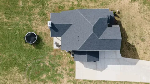 an aerial view of house with yard