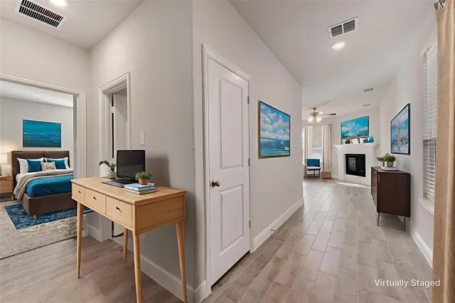 a view of a workspace with furniture and a window