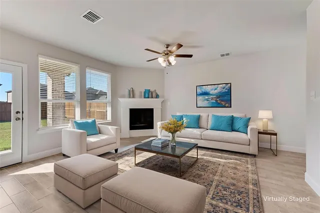 a living room with furniture a fireplace and a flat screen tv