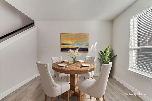 a view of a dining room with furniture and window