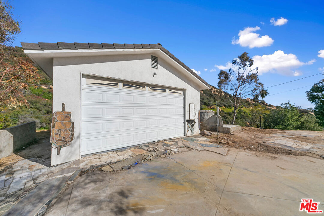 24641 Piuma Road Malibu, CA 90265 - Photo 13 of 40 a view of a house with a yard and garage