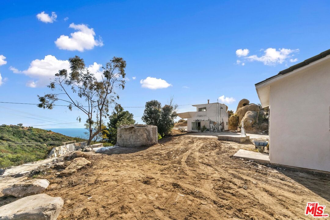 24641 Piuma Road Malibu, CA 90265 - Photo 19 of 40 a view of a bedroom with a bed and gym equipment