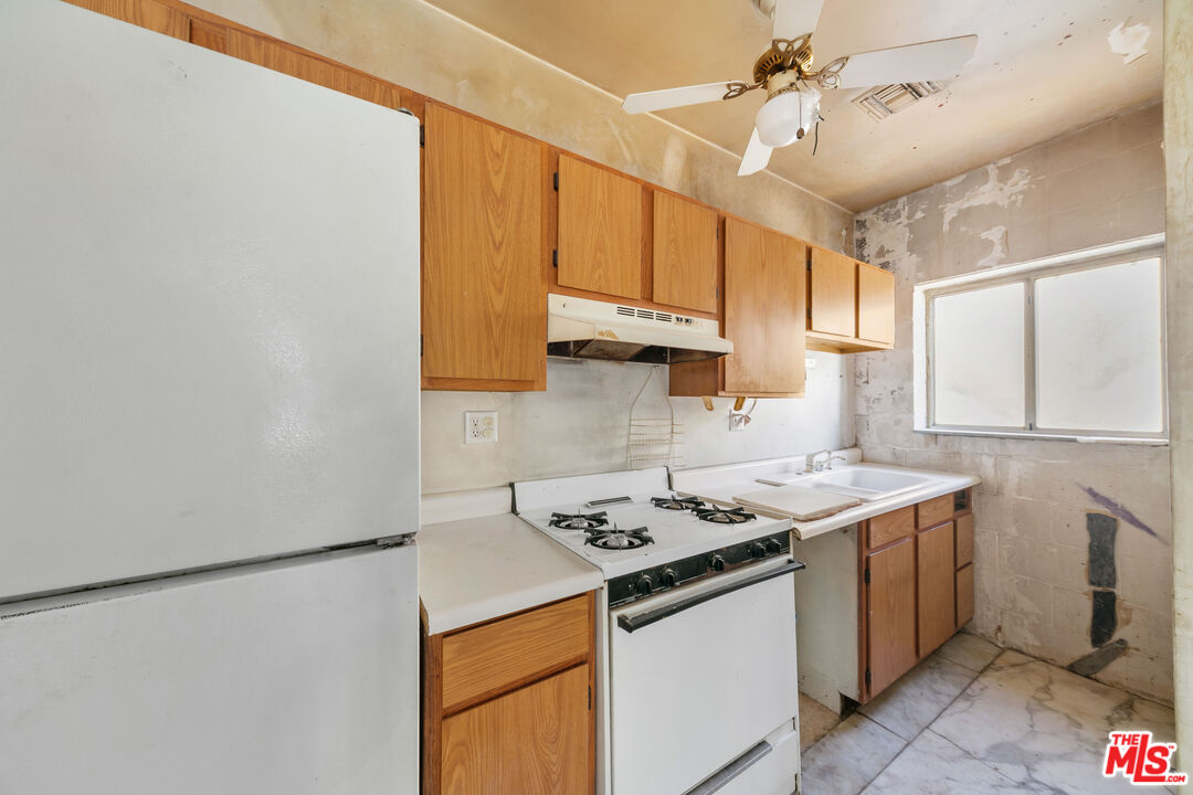 24641 Piuma Road Malibu, CA 90265 - Photo 23 of 40 a kitchen with a sink a stove cabinets and a window