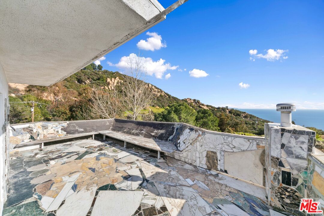 24641 Piuma Road Malibu, CA 90265 - Photo 33 of 40 a view of a terrace with a yard