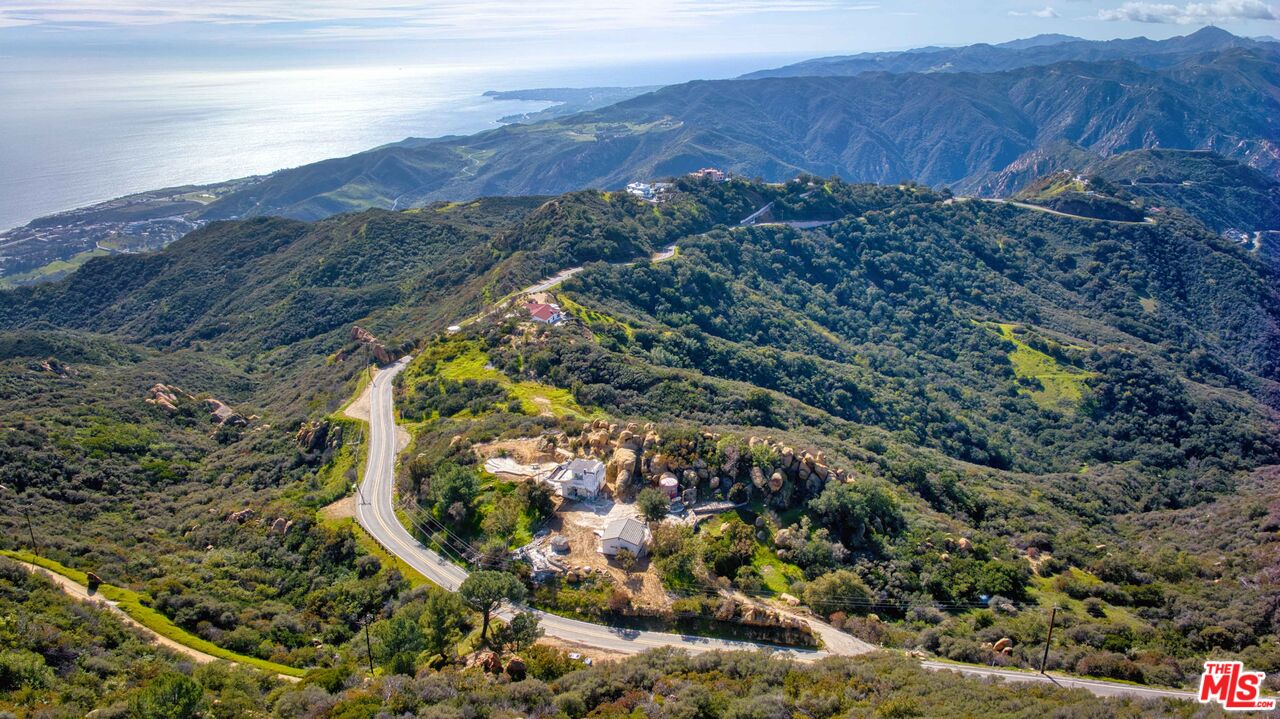 24641 Piuma Road Malibu, CA 90265 - Photo 37 of 40 a view of a lush green field with mountains in the background