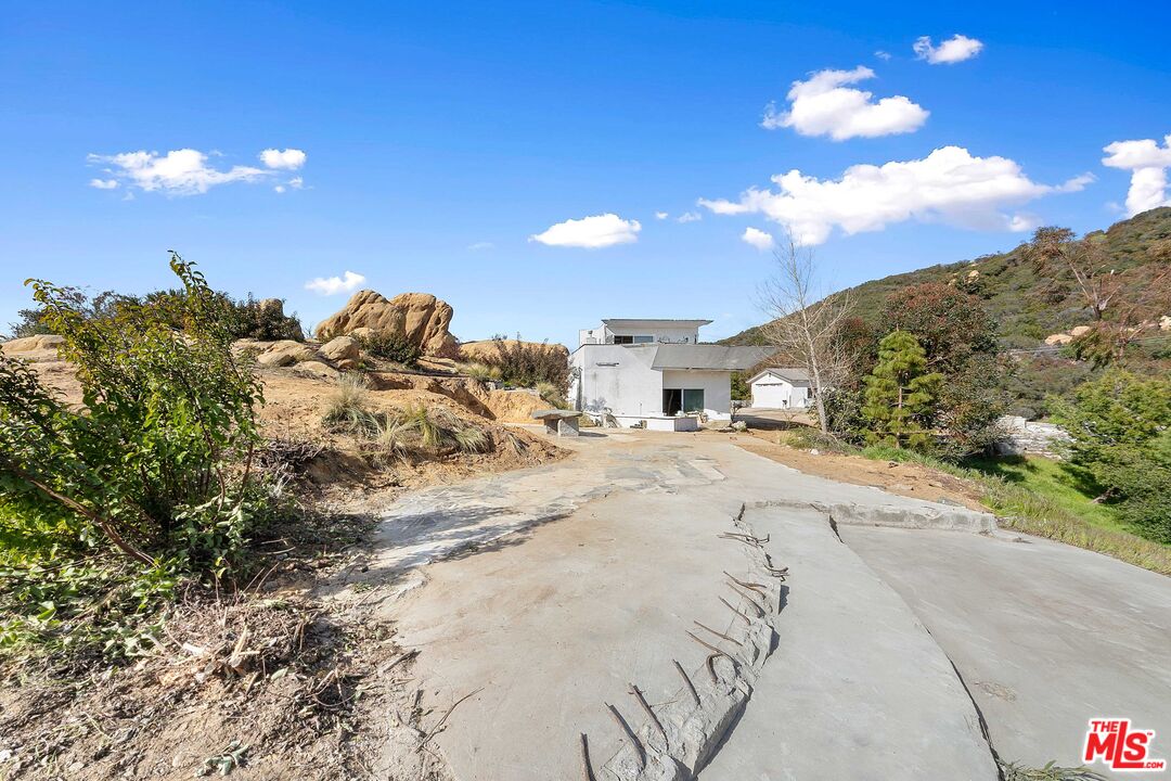 24641 Piuma Road Malibu, CA 90265 - Photo 7 of 40 a view of dirt road with a building in the background