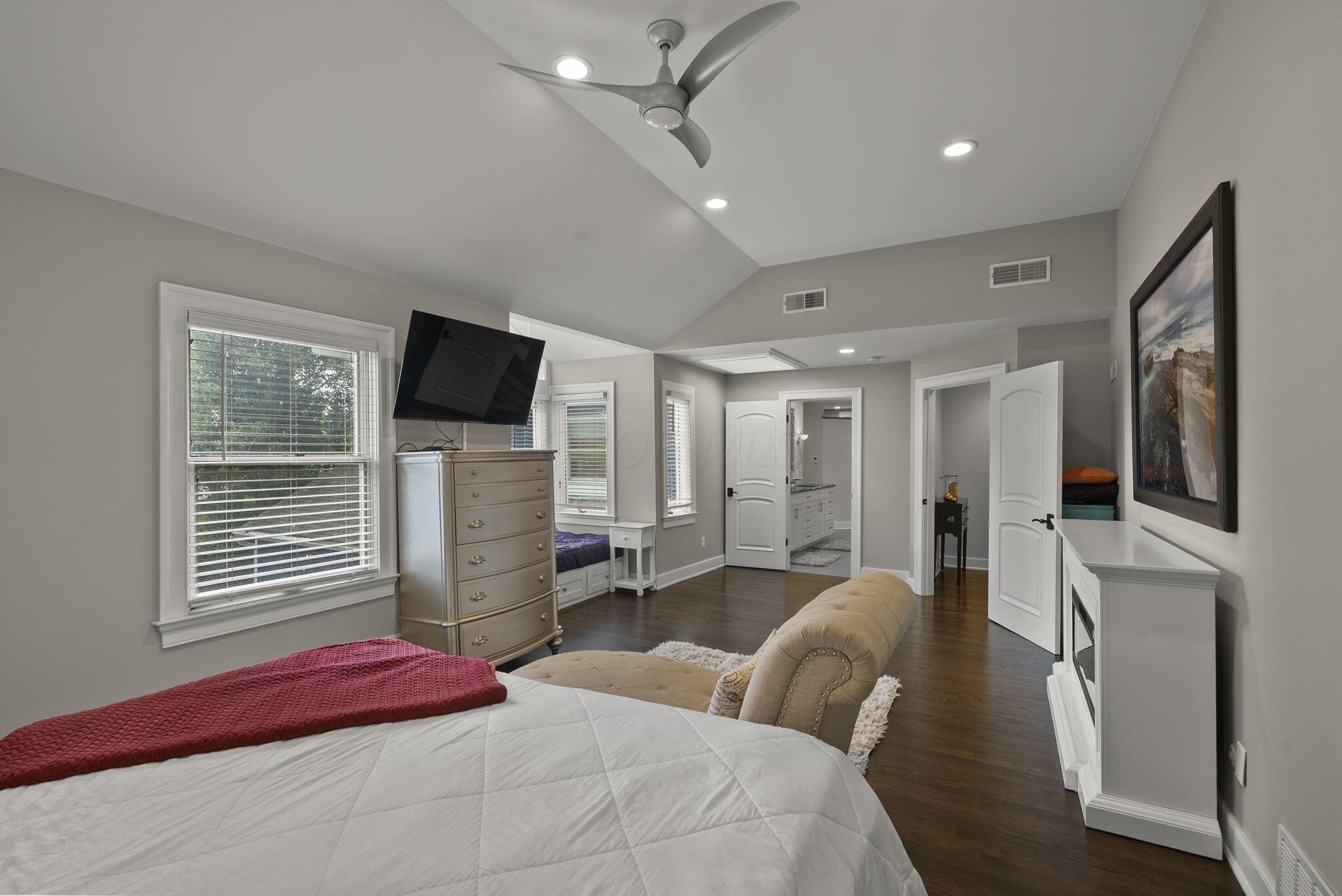 1851 Berkshire Road Columbus, OH 43221 - Photo 33 of 125 Spacious primary bedroom, high ceilings, ample light, featuring skylight, reading space or day bed overlooking the backyard.