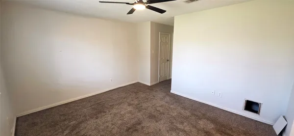 a view of a room with a ceiling fan