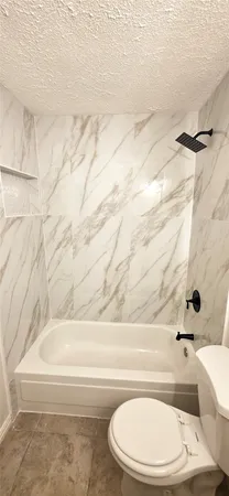 a bathroom with a bathtub and shower