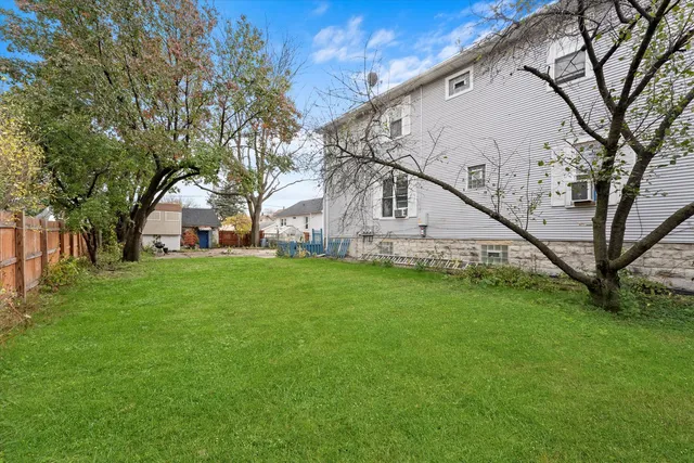 a view of house with backyard