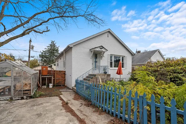 a front view of house with wooden fence