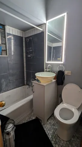 a bathroom with a sink toilet and shower
