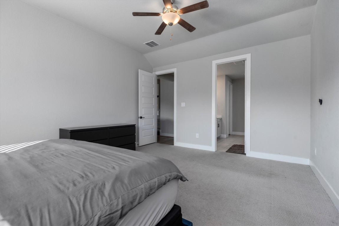 17828 Hanson Ridge Drive Montgomery, TX 77316 - Photo 23 of 47 a bedroom with a large bed and a ceiling fan