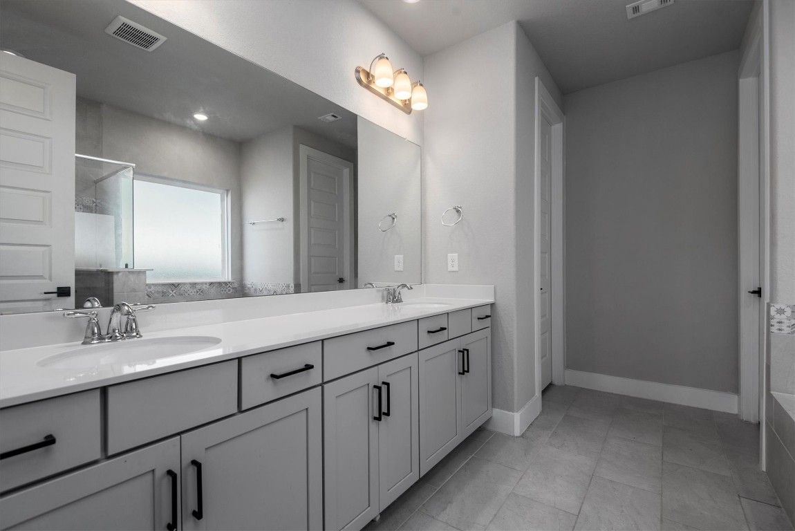 17828 Hanson Ridge Drive Montgomery, TX 77316 - Photo 25 of 47 a bathroom with a double vanity sink and a mirror