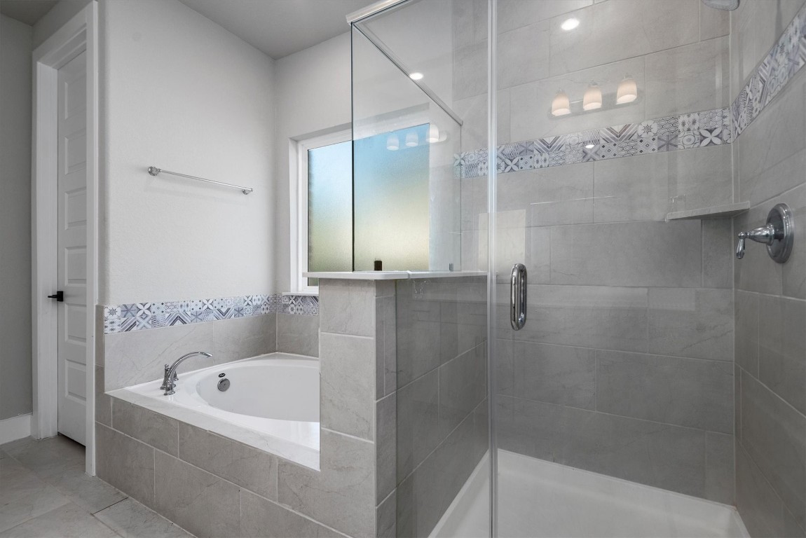 17828 Hanson Ridge Drive Montgomery, TX 77316 - Photo 26 of 47 a bathroom with a bathtub and a shower