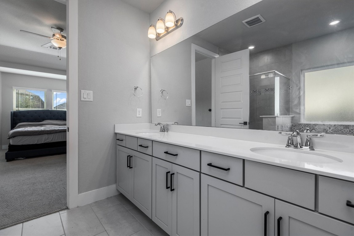 17828 Hanson Ridge Drive Montgomery, TX 77316 - Photo 27 of 47 a bathroom with a double vanity sink and a mirror