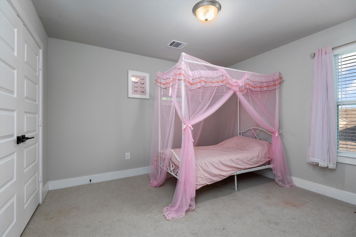 17828 Hanson Ridge Drive Montgomery, TX 77316 - Photo 37 of 47 a bedroom with a bed and a window
