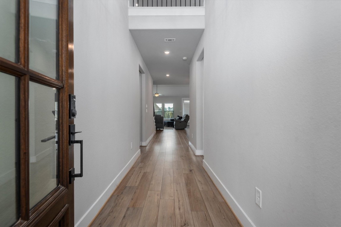 17828 Hanson Ridge Drive Montgomery, TX 77316 - Photo 4 of 47 a view of a hallway with wooden floor and staircase