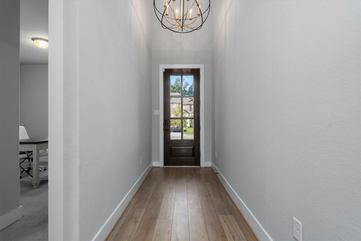 17828 Hanson Ridge Drive Montgomery, TX 77316 - Photo 5 of 47 a view of a hallway with wooden floor and a potted plant