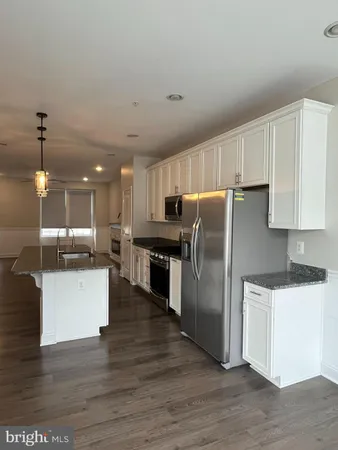 a kitchen with stainless steel appliances granite countertop a stove a sink and a granite counter tops