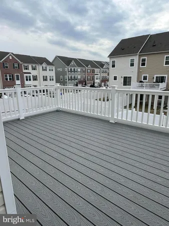 a large kitchen with stainless steel appliances granite countertop a stove a sink a refrigerator and a wooden floor