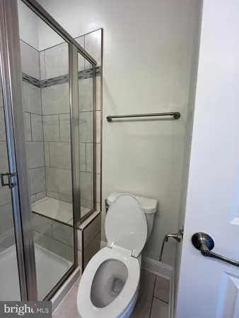 a bathroom with a shower a toilet and a sink