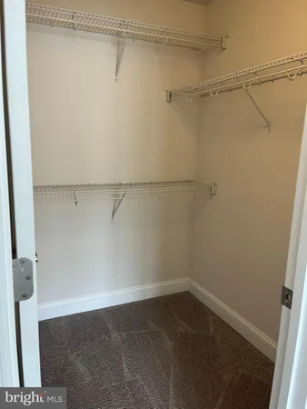 an empty room with large windows