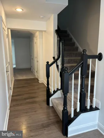 a view of entryway and hall with wooden floor