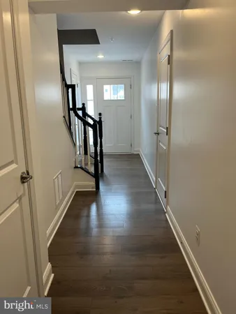 a view of a room with wooden floor and stairs
