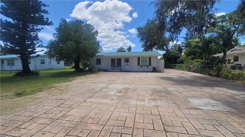 20710 Sandy Lane Estero, FL 33928 - Photo 2 of 4 a view of house with yard and trees in front of it