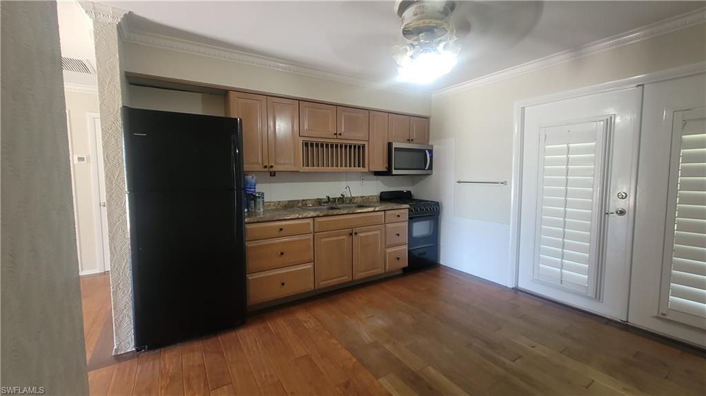 20710 Sandy Lane Estero, FL 33928 - Photo 3 of 4 a kitchen with a refrigerator stove and a sink