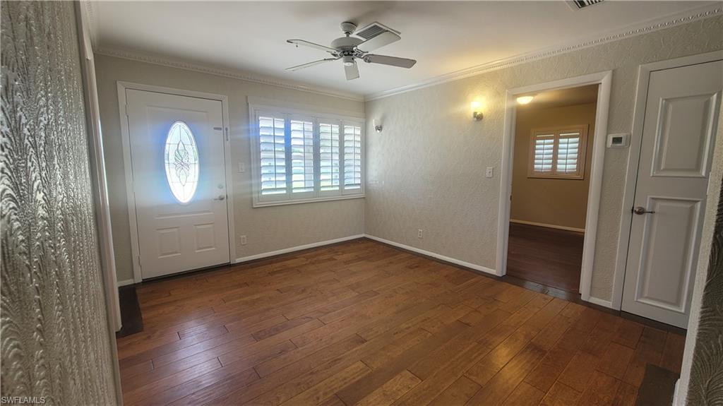 20710 Sandy Lane Estero, FL 33928 - Photo 4 of 4 a view of an empty room with wooden floor and a window