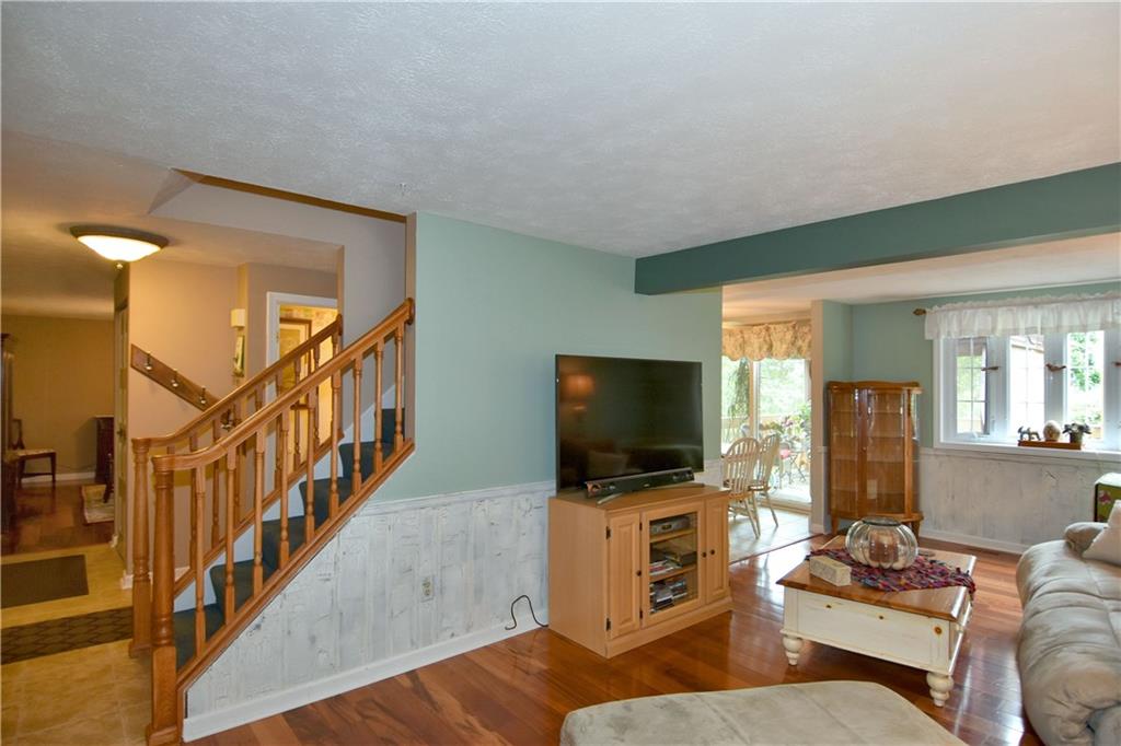 315 Ritter Road South Sewickley, PA 15143 - Photo 3 of 25 Newer hardwood flooring is provided in both the family room and dining room.